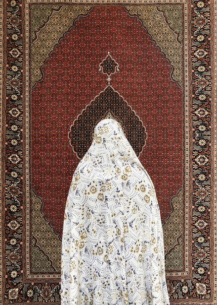 Woman in white patterned garment standing in prayer pose within ornate dark archway framed by decorative border.