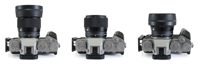 Three vintage rangefinder cameras with interchangeable lenses mounted on top, shown from above.