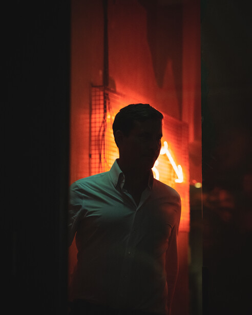 A man climbs the stairs to greet his friends at a popular bar in central London.