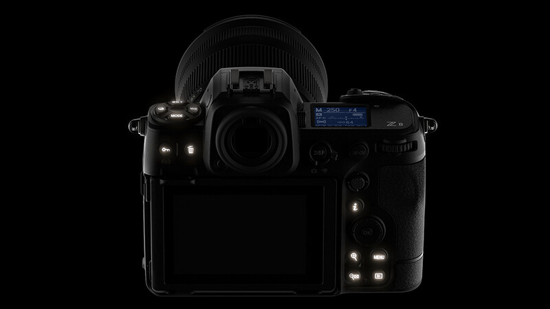 Professional mirrorless camera shown from front and back against black background.