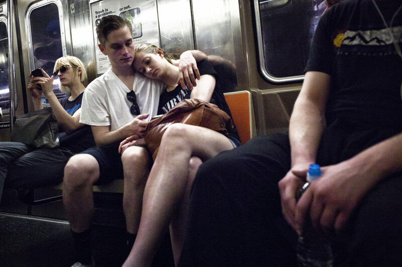 Couple hugging on a subway train