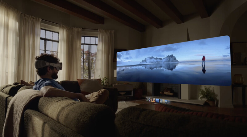 Person watching a large display screen showing a minimalist landscape with mountains and a figure reflected in still water.