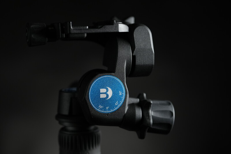 Ball head tripod mount with blue circular control dial featuring a B logo against dark background.
