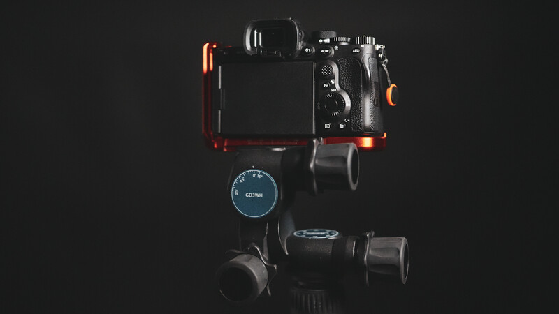 Professional camera rig with gimbal stabilizer and mounted monitor on dark background.