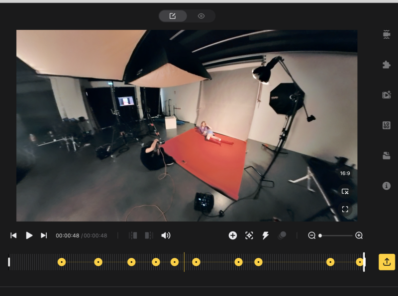 Screenshot of video editing software showing a studio setup with red backdrop and lighting equipment.