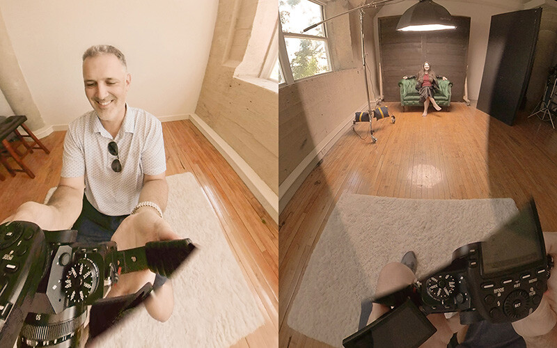 Wide-angle view of a photographer in a light-filled studio space with wooden floors.