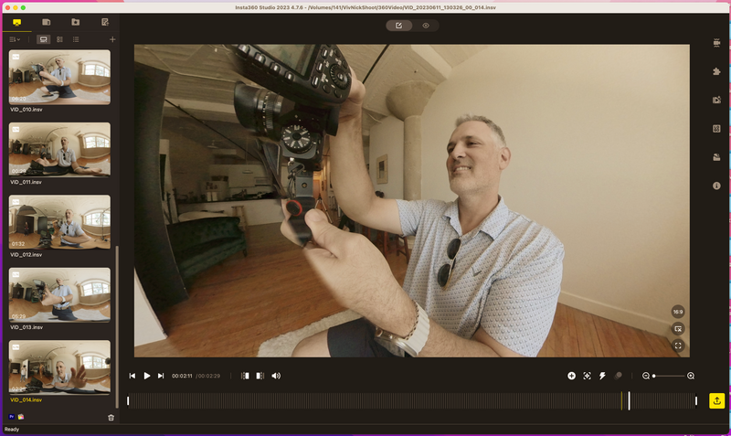 Screenshot of video editing software showing a man adjusting a camera mounted on a ceiling bracket.