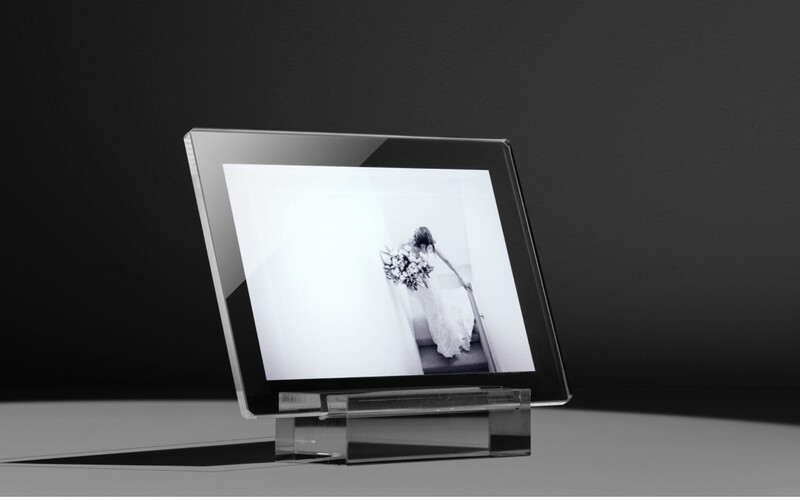 Digital tablet displaying a minimalist black and white portrait of a person with flowing hair against a neutral background.