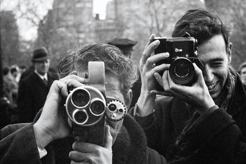Paul McCartney takes an image of press photographers in Central Park New York