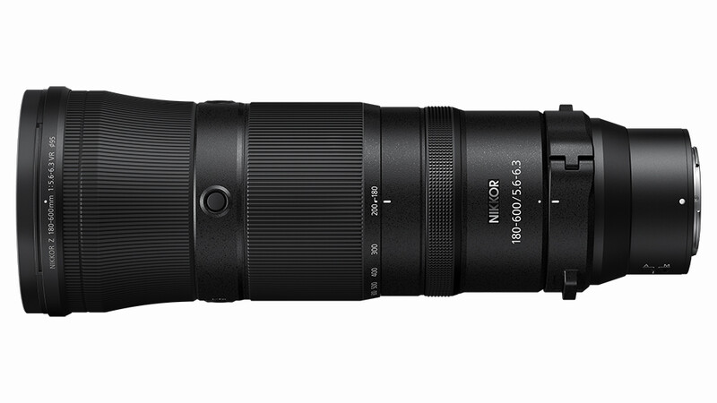 Black telephoto zoom lens with ribbed barrel and electronic contacts displayed against white background.