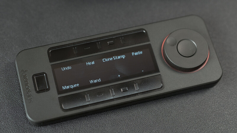 Overhead view of a smartphone displaying photo editing interface with tools and adjustment controls on gray surface.