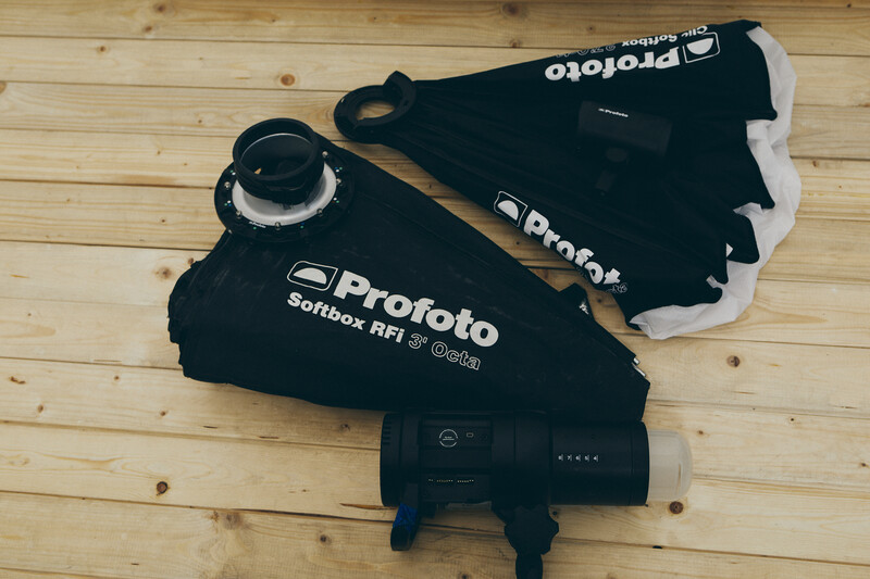 Profoto Softbox RFi lighting modifier with carrying case and battery pack on wooden floor.