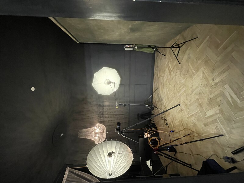 Professional photo studio setup with softbox lighting and dark walls.