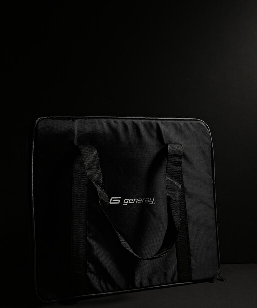 Black nylon camera or gear bag with dual handles displayed against dark background.