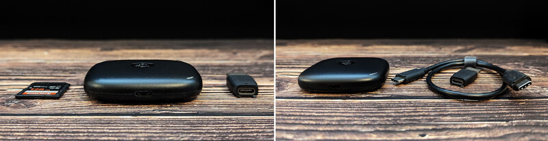Black wireless earbuds case with accessories laid out on wooden surface.