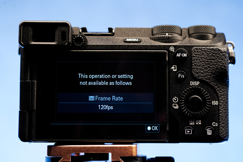Screenshot of a mirrorless camera's rear LCD screen displaying a frame rate menu error message.