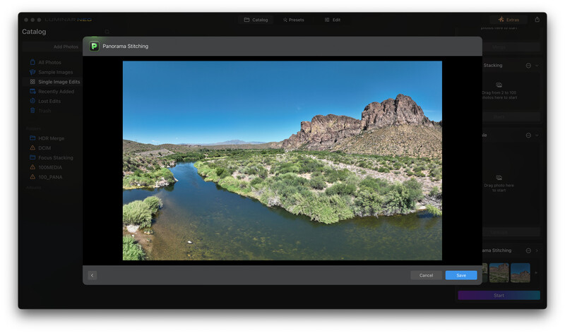 Desert landscape with a meandering river, rocky peak, and scrubland vegetation under clear blue sky.