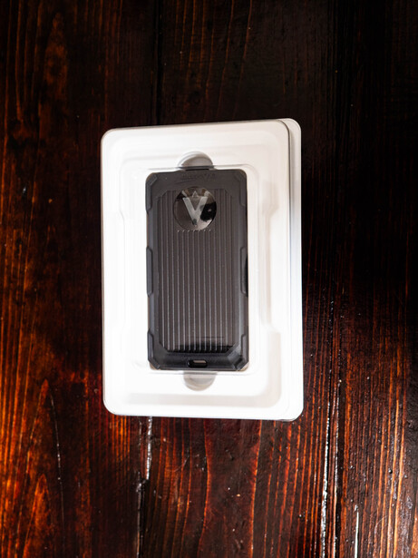 White electrical outlet plate with black toggle switch mounted on weathered dark wood wall.
