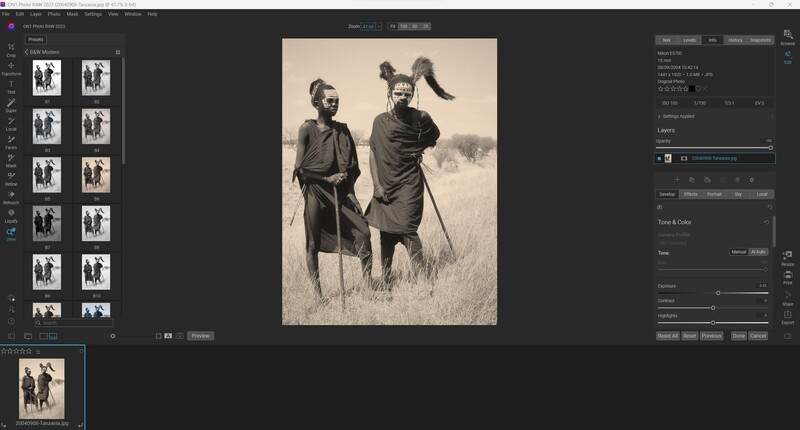 Two figures standing in grassland, one holding a walking staff, rendered in sepia tones with vintage film grain.
