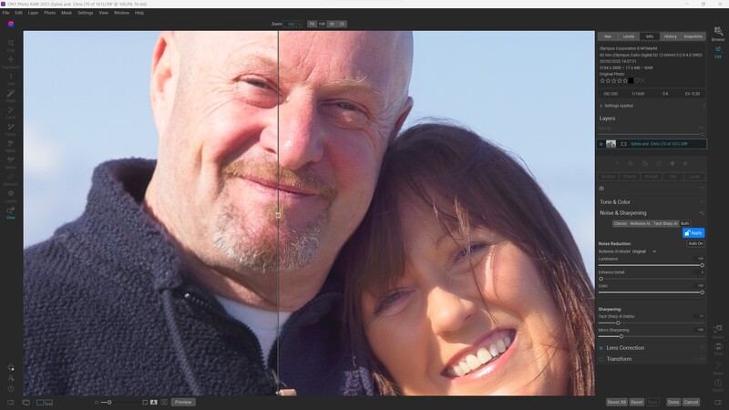 Two people smiling outdoors in natural sunlight, shot in close-up portrait style.