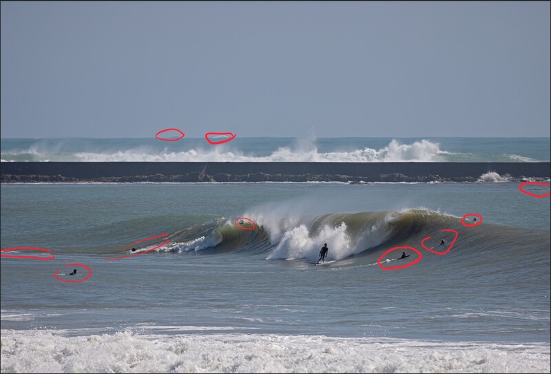 Surfer riding a large wave with red annotation circles overlaid throughout the ocean and sky.