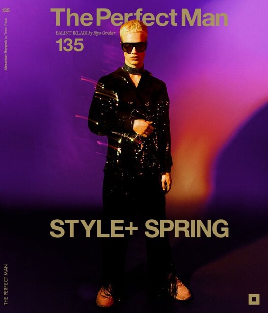 Magazine cover featuring person in black sequined jacket against purple and orange gradient background.
