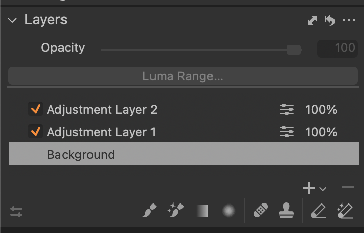 Screenshot of Layers panel showing two adjustment layers and a background layer with opacity and blending controls.