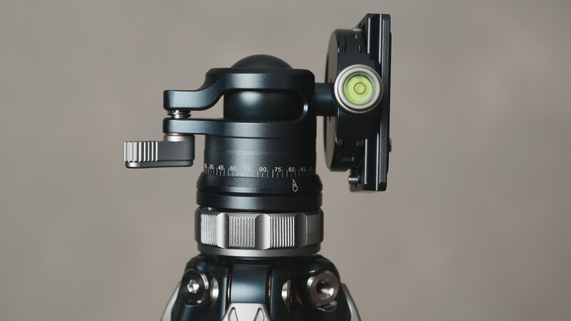Ball head tripod mount with fluid head base and side-arm extension bracket against neutral background.