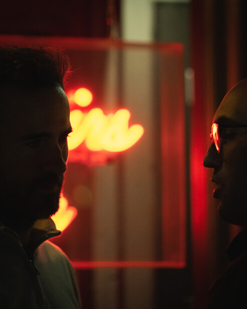 Two friends continue their talk as they leave a popular bar in London's Soho district.
