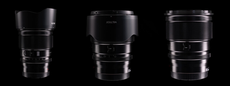 Three black camera lenses with lens hoods displayed against a black background.