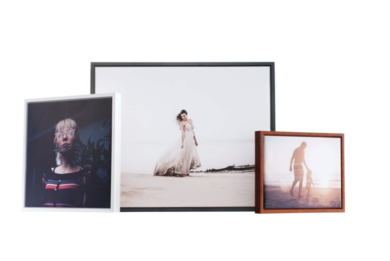 Three framed photographs displayed at different angles showing portrait and figure photography with warm, natural lighting.