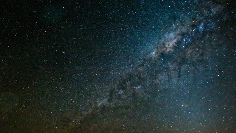 Milky Way galaxy stretching diagonally across a dark star-filled night sky.