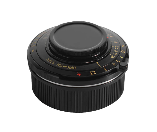 Vintage manual lens with ribbed focusing ring and aperture dial against white background.