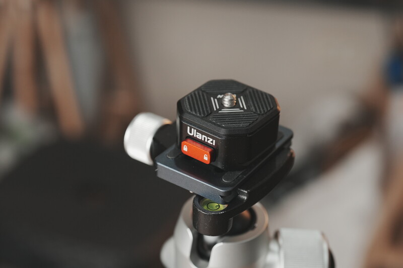 Ulanzi compact camera light mounted on tripod head with white diffuser attached.