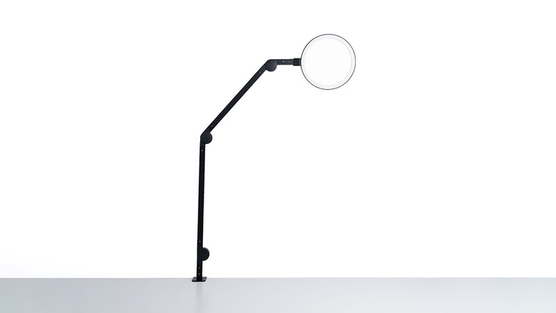 Illustration of an adjustable arm lamp with a spherical head mounted on a surface.