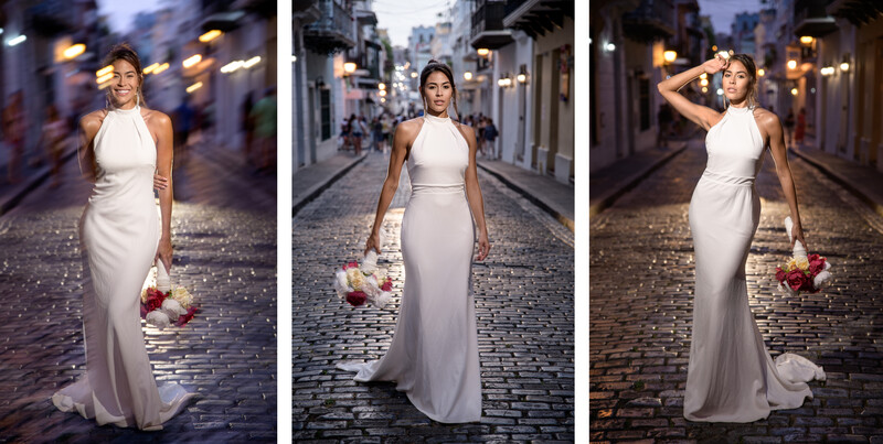 Woman in white halter gown holding bouquet on cobblestone street at dusk.