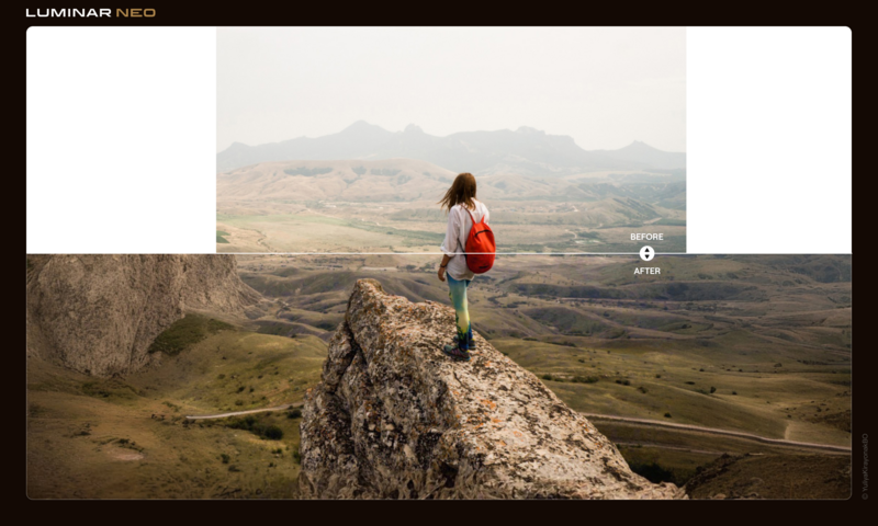 Hiker in red backpack standing on rocky outcrop overlooking vast valley landscape.