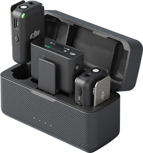 Multi-device charging dock with organized compartments for camera batteries, cables, and mobile devices.