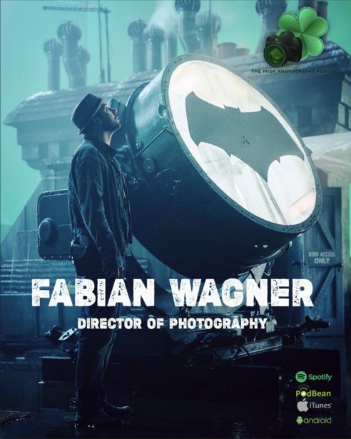 Graphic design featuring a large spotlight with a bat symbol and a silhouetted figure holding professional photography equipment.