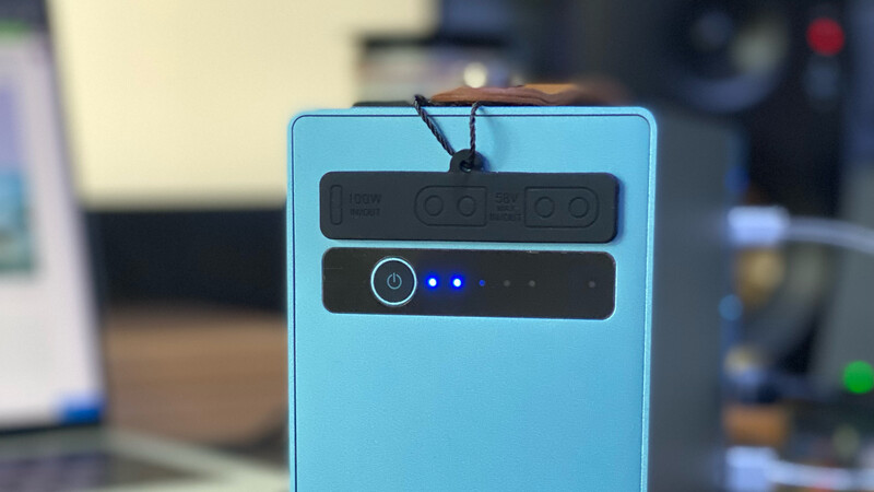 Rear view of a light blue smartphone showing dual camera module with LED flash and status indicator lights.