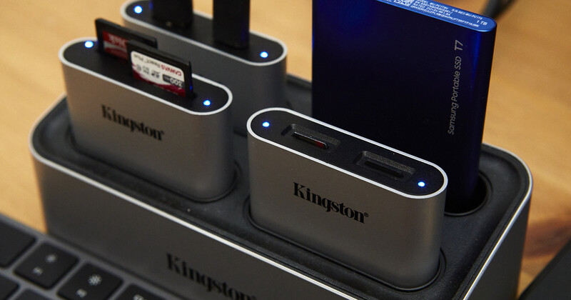 Kingston external hard drive docking station with multiple connected drives and blue indicator lights.