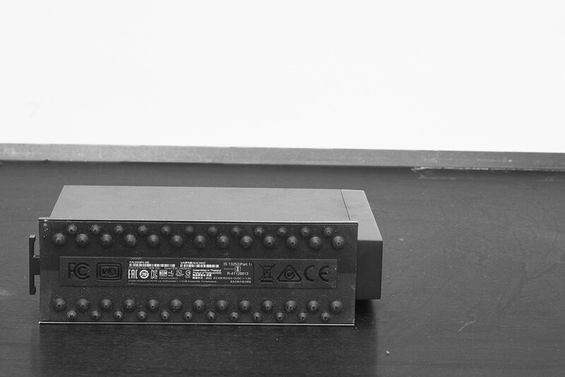 Back panel of a professional audio mixing device with multiple input/output connections and regulatory markings.