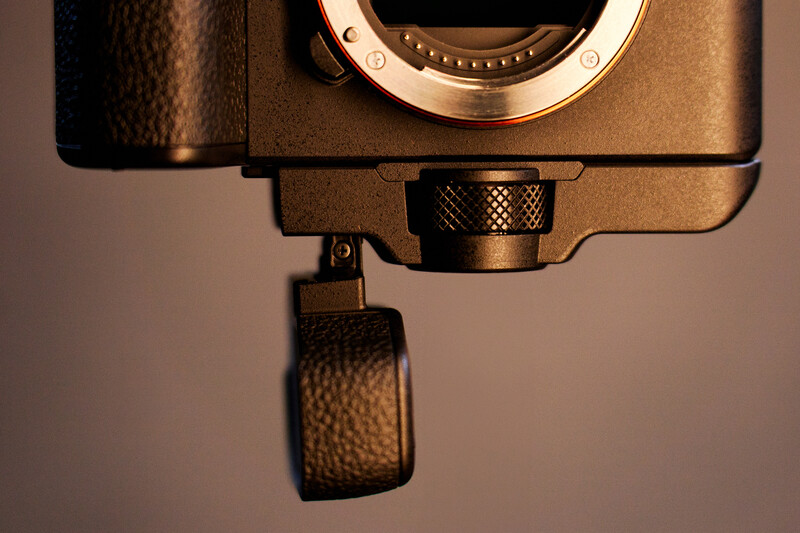 Top-down view of a mirrorless camera body showing the lens mount and attached camera strap.