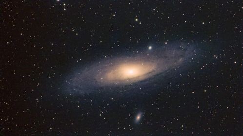 Spiral galaxy with bright central core surrounded by dust lanes and stars against dark space.
