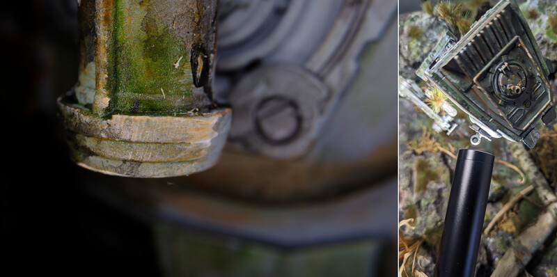 Close-up details of vintage camera equipment showing weathered metal surfaces with patina and moss growth.