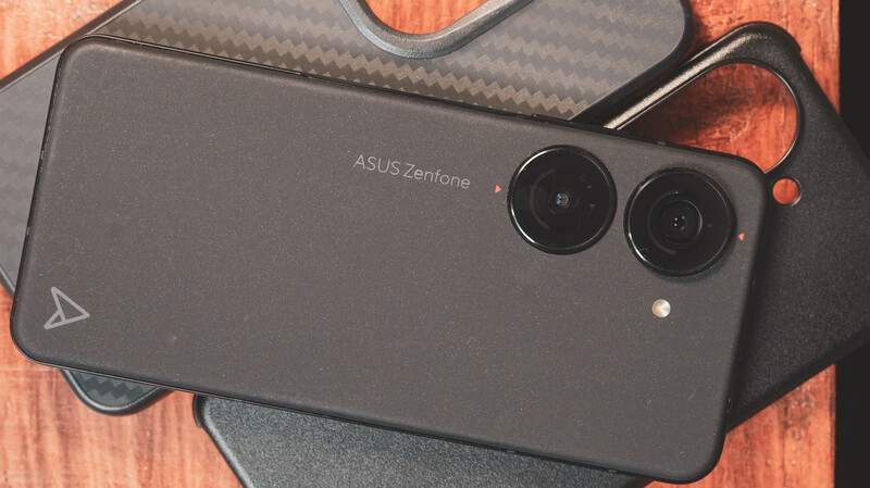 ASUS Zenfone smartphone with dual rear camera lenses displayed on wooden surface.