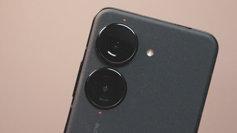 Dual-lens smartphone camera module mounted on dark device with flash and sensor visible.