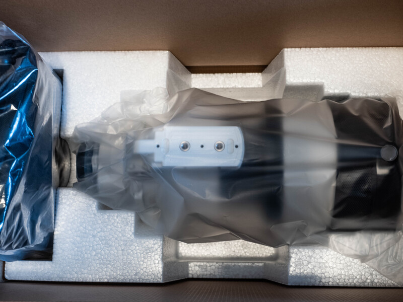 Photography lighting equipment packed in a shipping box with foam padding and protective wrapping.