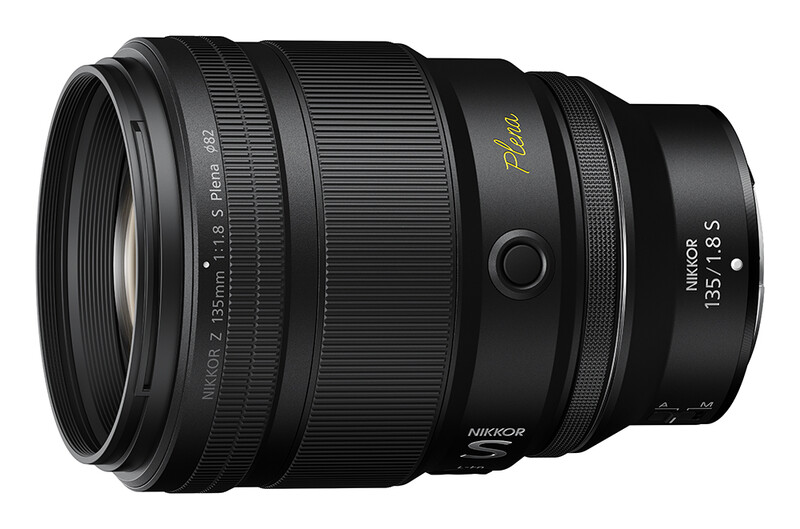 Nikon Z 85mm f/1.8 S lens with gold accents on black barrel against white background.