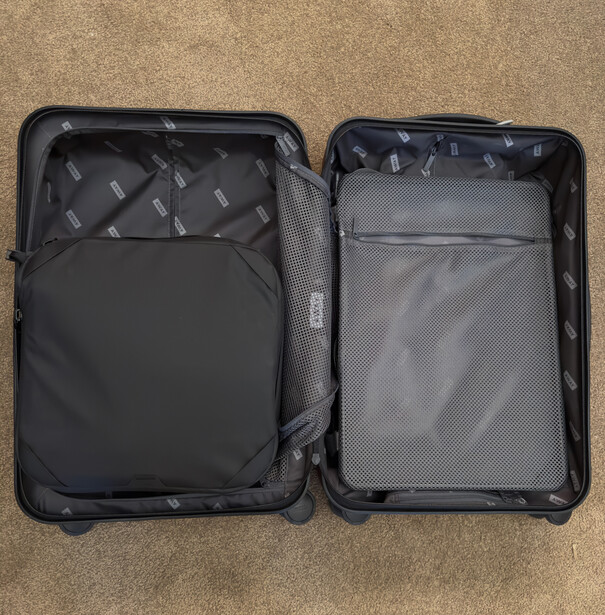 Open hardshell luggage displaying packing cubes and organizational compartments.